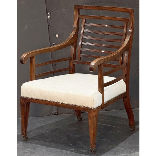 A fine period Georgian vernacular reading chair from England, circa 1820, featuring an elegant frame with a comfortable...