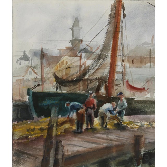Arranging their yellow fishing nets, the fishermen in this Eve Nethercott watercolor are surrounded by fishing vessels and...
