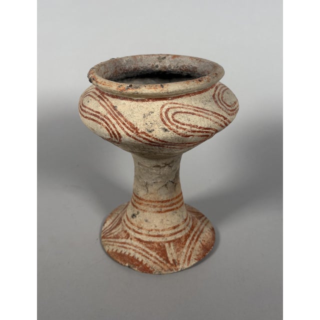 Globular terracotta vases on feet from Ban Chiang Ochre curvilinear decoration on beige slip Thailand. Ban Chiang culture....