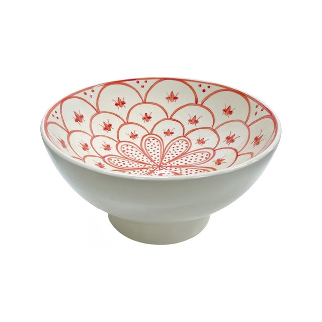 This handcrafted ceramic vessel features a vibrant red floral motif inspired by Mediterranean artistry. The intricate...
