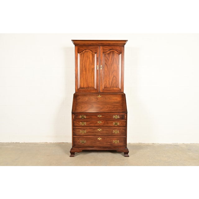 A beautiful Georgian or Chippendale style bureau with drop front secretary desk and bookcase hutch top By Henkel Harris...