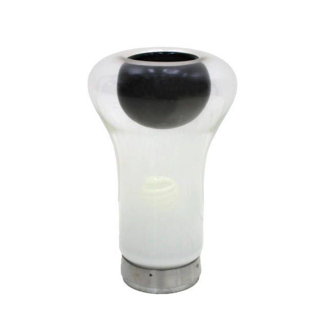 Model Saffo desktop lamp. Designed by Angelo Mangiarotti and produced by Artemide. Made of polished aluminum and blown...