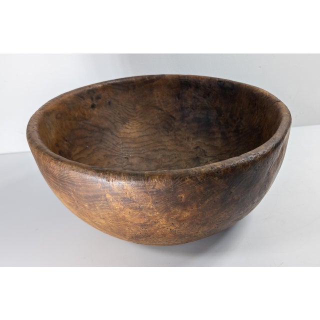 We are selling this great 19th Century primitive hand carved elm bowl with small burl. The bowl has very elegant high...