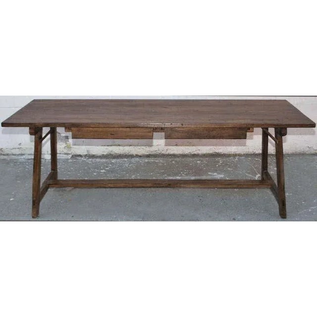 This primitive work table has lots of character. Both sides are symmetrically identical. The two drawers can be pulled out...