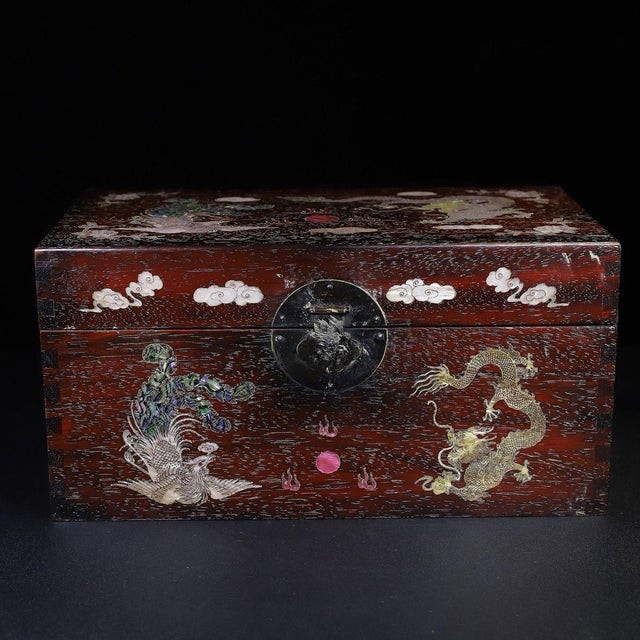A beautifully crafted Chinese rectangular box, likely made of Zitan wood. The box features a hinged lid with brass...