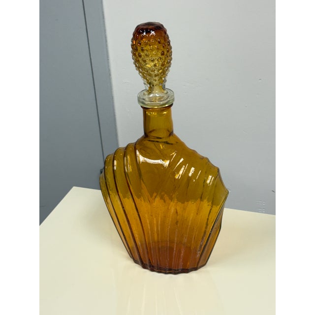 Design Plus Gallery presents a Vintage Pressed Glass Fan Form Decanter + Hobnail Stopper. Molded amber glass forms a broad...