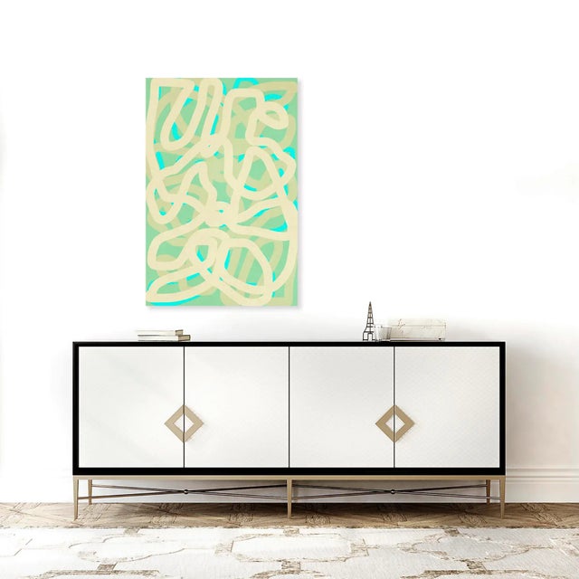 Angela Cameron's squiggle lines artwork plays with colour in a contemporary way. Cream and teal hues mingle and intersect,...
