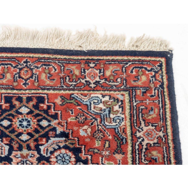 Persian Hamadan Wool Rug, with floral and geometric design on blue and red ground. 3' 2" L x 2' W. Provenance: The...