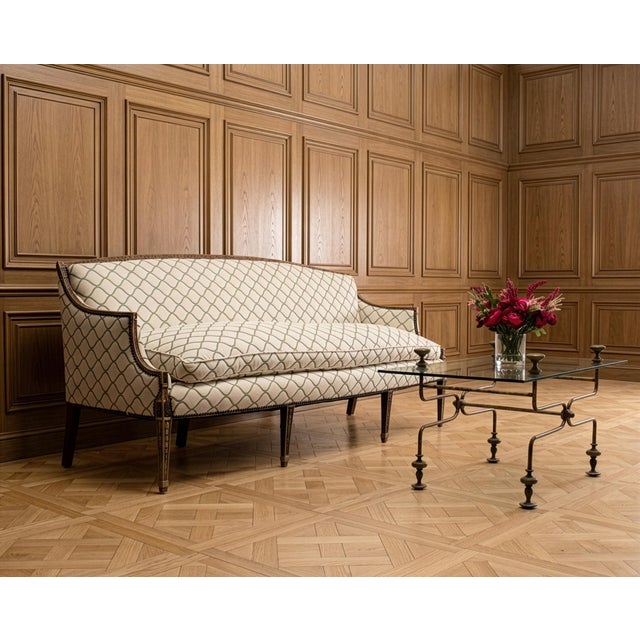 An elegant 19th century English Georgian Cabriole sofa or settee, featuring a beautifully Neoclassical decorated hardwood...