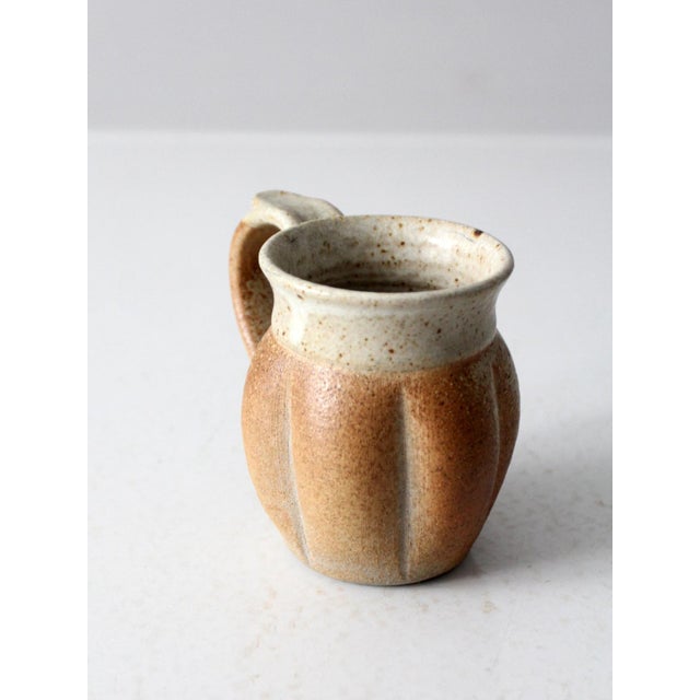 This is a vintage studio pottery mug. Signed by the artist, the handmade ceramic art piece has a bulb ridged design with...