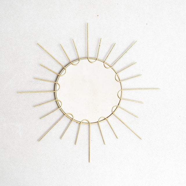Mid-Century Modern sunburst mirror brass, circa 1960 Traditionally manufactured in France. By unknown designer. In...