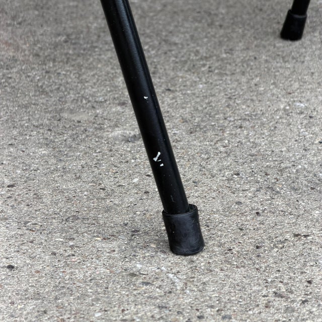 This is a pair of early Eero Saarinen for Knoll executive side chairs. They feature slim black metal legs, and an off-...