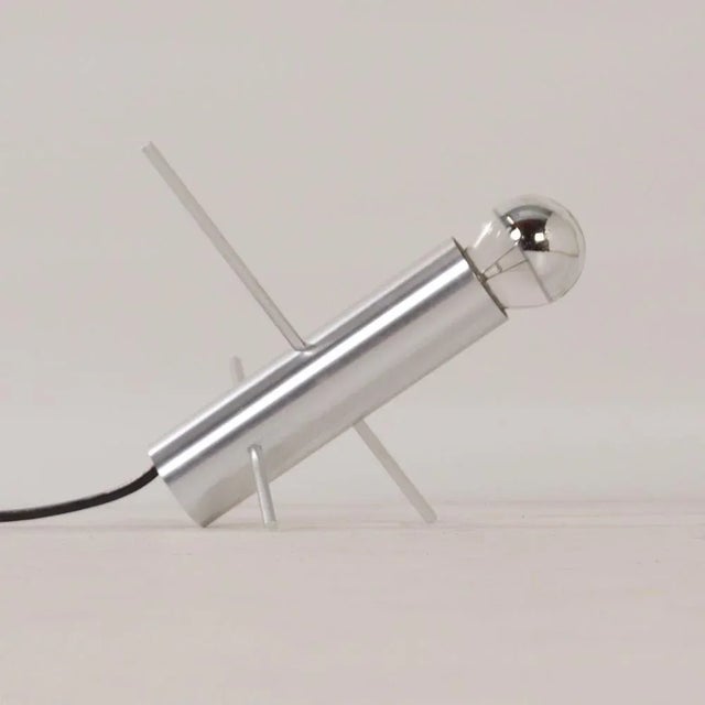 Raak grasshopper lamp model r-60 designed by otto wasch for raak in 1962. A rod, two pins, and a lamp. By moving the pins...