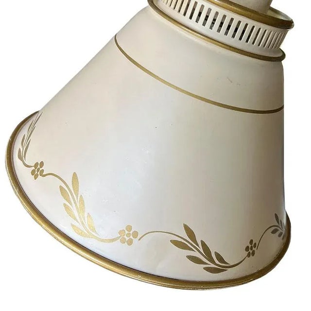 A pretty dual-arm tole table lamp. This piece will bring a soft glow to any space. Imagine it in a little girl's room in...