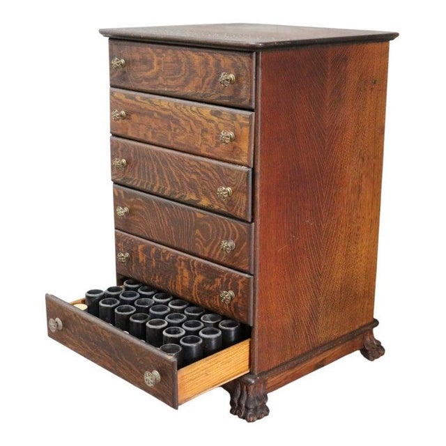 This antique Edison quarter sawn oak cylinder cabinet features six drawers, each designed to store phonograph cylinders....