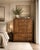 A wonderful campaign tallboy from the Drexel Accolade range. Beautiful wood grain contrasts splendidly with the gleaming...