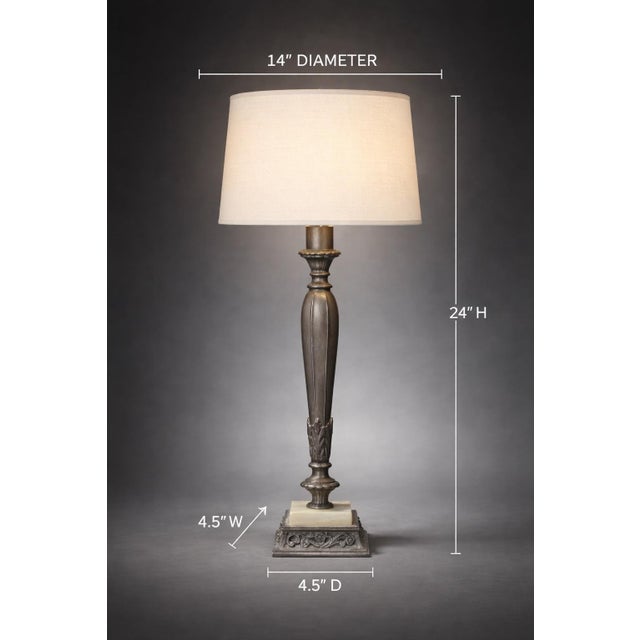 A refined Rembrandt-style table lamp featuring a sculptural pewter-finish column, solid onyx base, and clean linen drum...