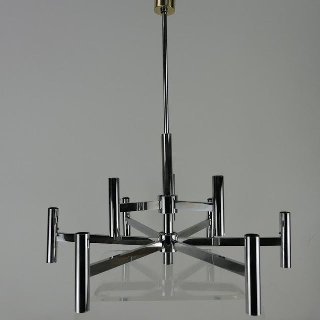 Large simple chrome -plated chandeliers with 9 light sources from the 1960s from Italy from Sciolari. In a very good...