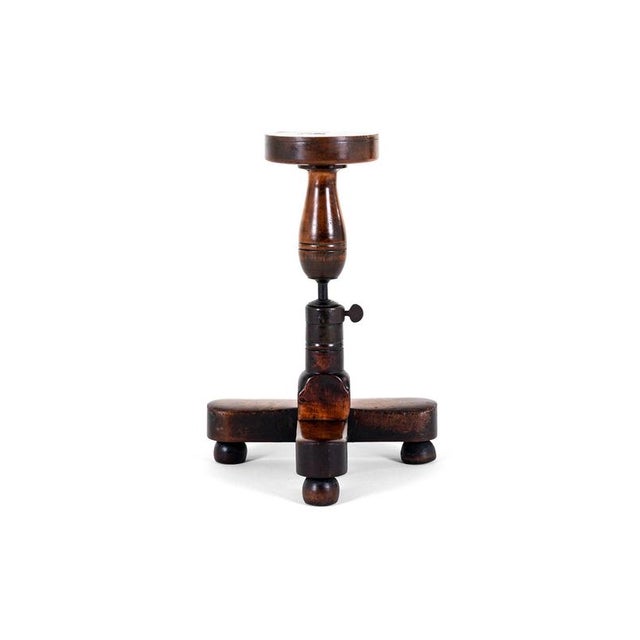 A 19th century extendable gilders wheel in elm on a t shaped base. The thick top is made from a single piece of elm with a...