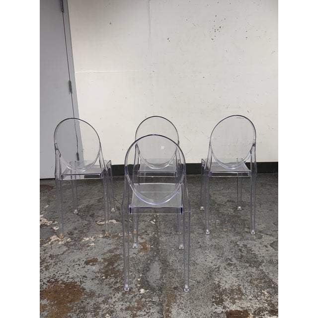 Design Plus Gallery presents a Set of Four Philippe Starck Style Ghost Side Chairs. These transparent side chairs are...