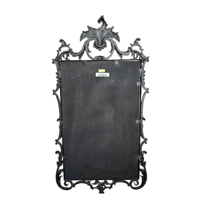 An exquisite decorative wall mirror by Maitland-Smith, showcasing an elaborate combination of sculptural ornamentation,...