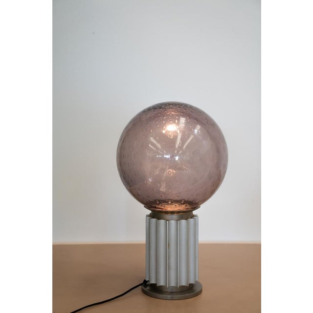 Colored puffed glass sphere table lamp, 60s This piece is attributed to the mentioned designer/maker. It has no...