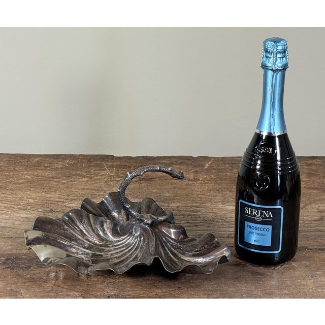 Vintage silverplate shell form basket with an integrated arched 'coral' handle and applied shell details, featuring a...