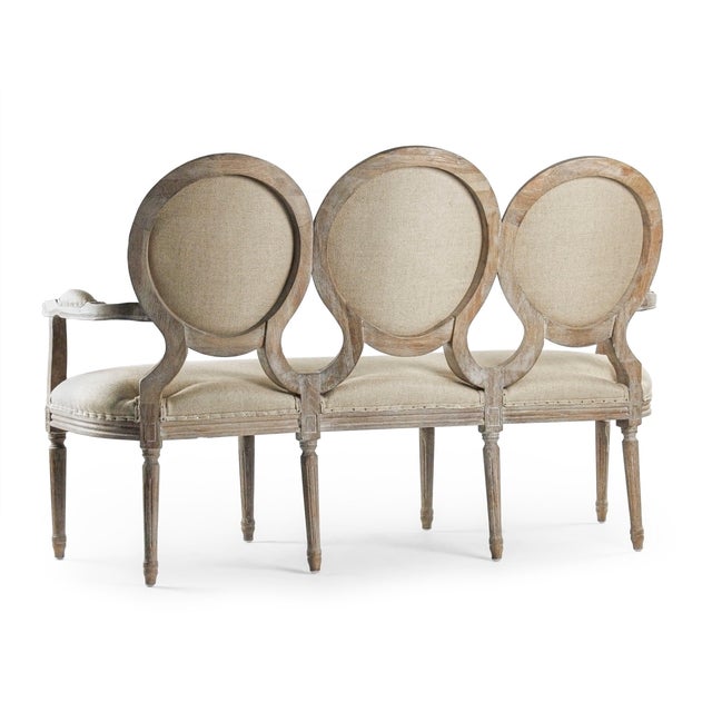 The Medallion Bench from Zentique showcases three upholstered oval medallion backs on a limed grey oak frame. This version...