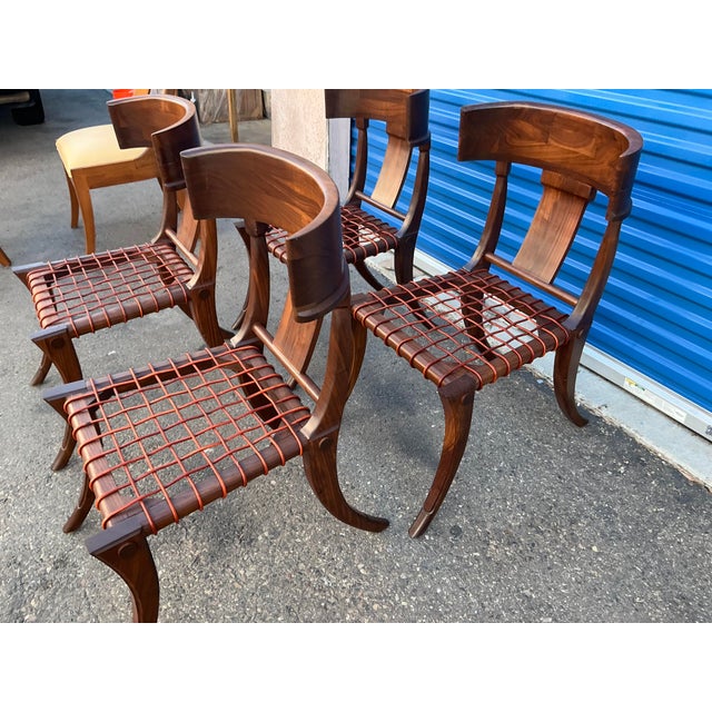 Solid walnut Robsjohn Gibbings style Klismos dining chairs. The chairs are in flawless condition. Satin finish. Leather...
