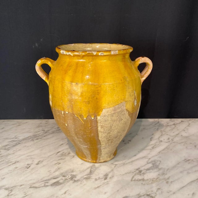 Antique Country French Confit Pot with double handles and classic mustard yellow glaze. Used originally to preserve...