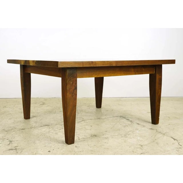 This handmade coffee table is made of walnut with tapered legs. This piece was handcrafted in our table shop located in...