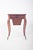 Rosewood potty table. with sharply curved feet, ending in small metal wheels. The top is cut at the ends, with a wavy...