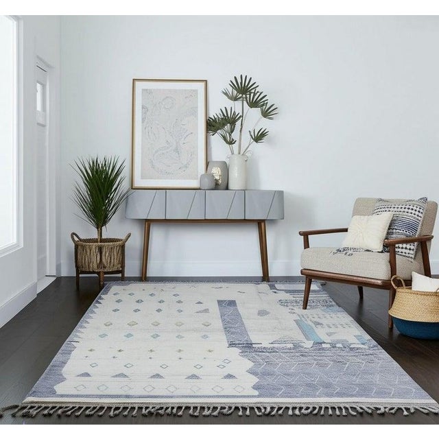 This hand knotted pile rug features a primary gray color palette and is crafted from durable wool. The construction...