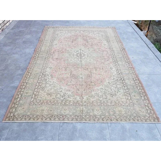 A Turkish handmade vintage Anatolian Oushak rug. We collect old vintage antique rugs from Anatolia, which is the eastern...