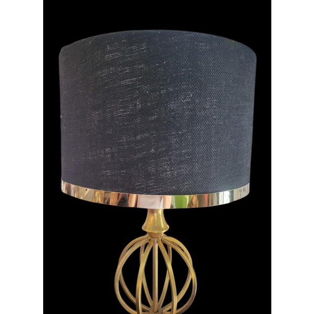 A wonderful pair of very tall gold iron sphere shaped table lamps with custom linen black brass trim shades. The lamps are...