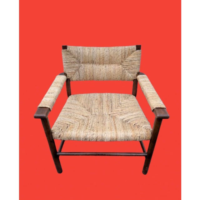 This Midcentury modern lounge chair is designed in the style of Mel Smilow or Charlotte Perriand. Featuring a dark wood...