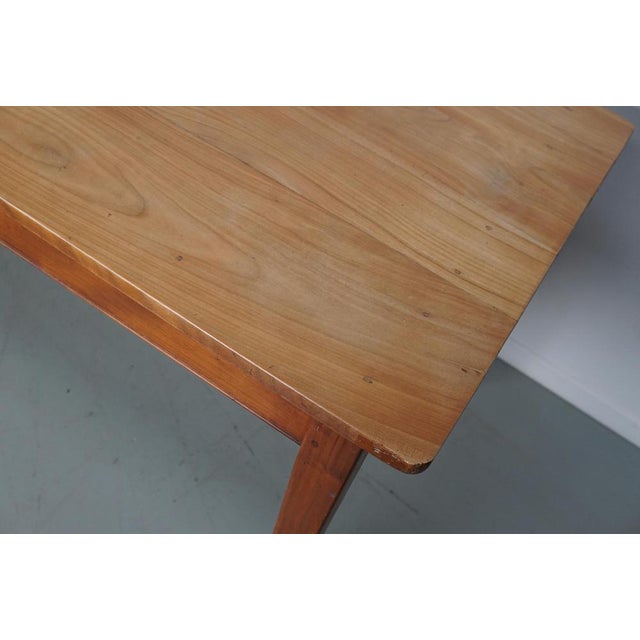 This elegant table was made in France in the early/mid 20th century. It has a tabletop from cherry with beautiful grain...