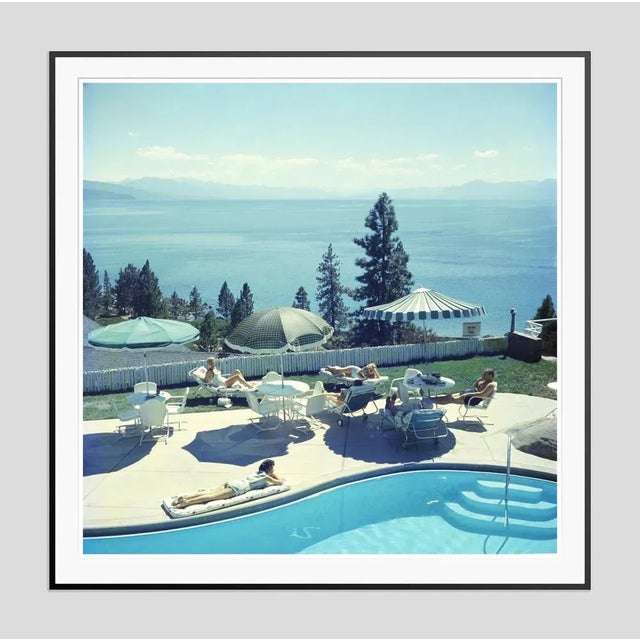 Relaxing at lake tahoe' by slim aarons open edition a group of people relaxing by a pool near lake tahoe, california,...