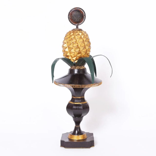 Standout pair of midcentury Italian tole pineapple garnitures or objects of art featuring stylized finials over pineapples...