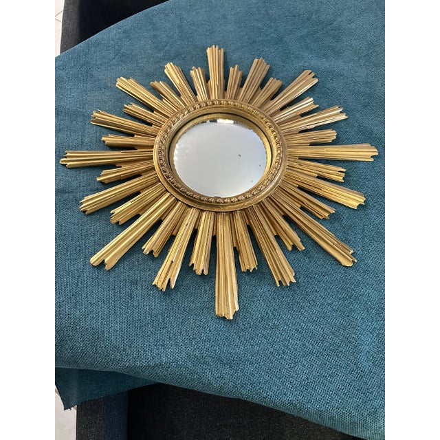 Large 60cm sunburst mirror, known as a witch's eye, vintage French, 1960s. Entirely made of gold-painted resin with a 20cm...