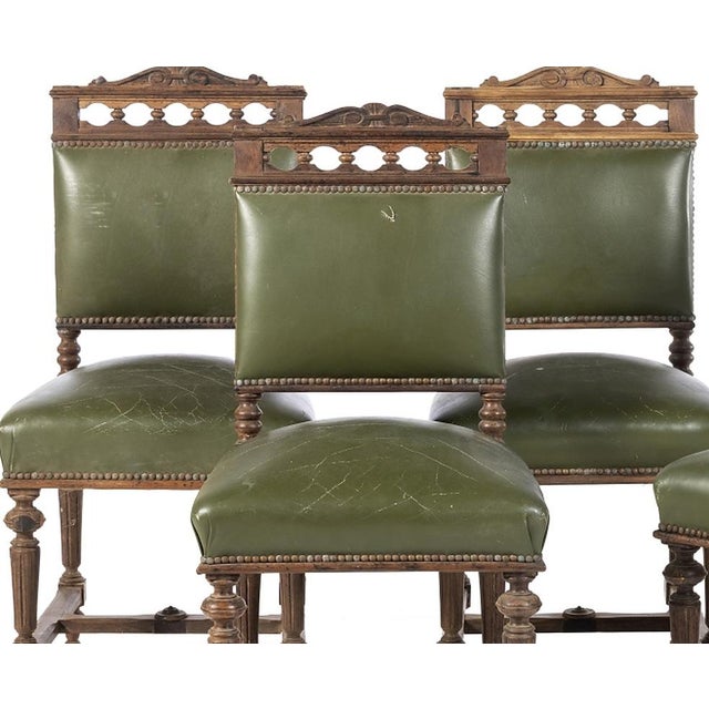 Set of four romantic chairs - 19th century. Portuguese, 19th century; carved oak wood. Backs and seats in green leather....