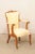 A French pair of carved-wood and upholstered fauteuil armchairs from the early to mid 20th century. This pair of armchairs...