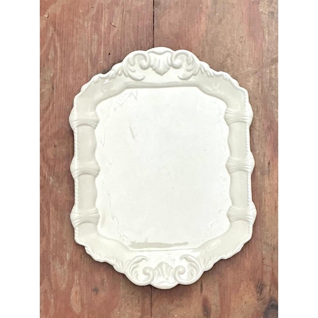 This vintage platter is a sculptural piece of white ceramic, shaped as a shallow, shaped-rectangular tray with a softly...