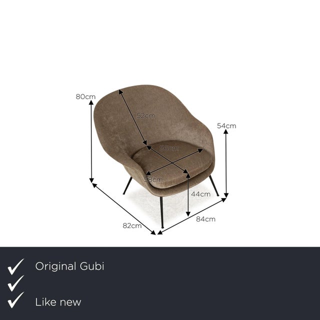 The BAT armchair from Gubi is covered in a brown fabric and stands on black feet. The minimalist design and modern look...