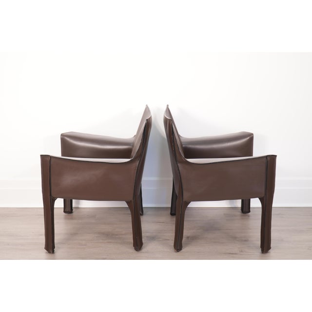 A sleek pair of Cab 414 armchairs in brown leather by Mario Bellini for Cassina. Very comfortable, lightly used lounge...