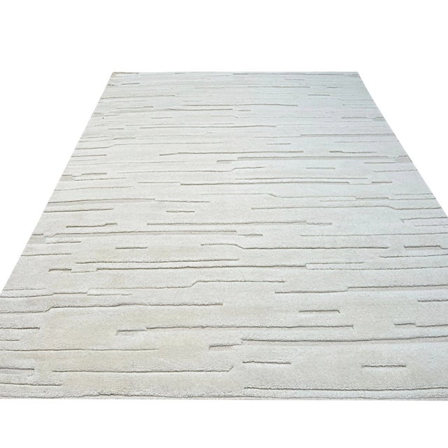 Para Vibrant White Hand Knotted Wool Rug, Country of Origin: India. This exceptional piece exemplifies the finest...