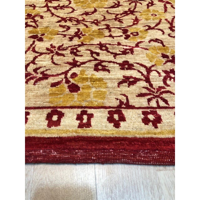 Celia Unique Ivory Hand Knotted Afghan Wool Rug, Country of Origin: India. This exquisite piece showcases the exceptional...