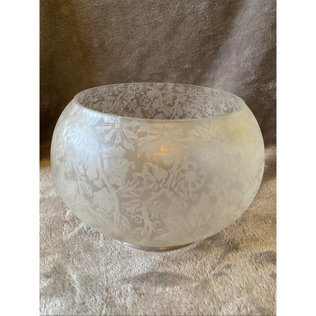 6" wide 5" tall This striking lamp shade is crafted from glass with a smooth, rounded silhouette. The exterior surface is...