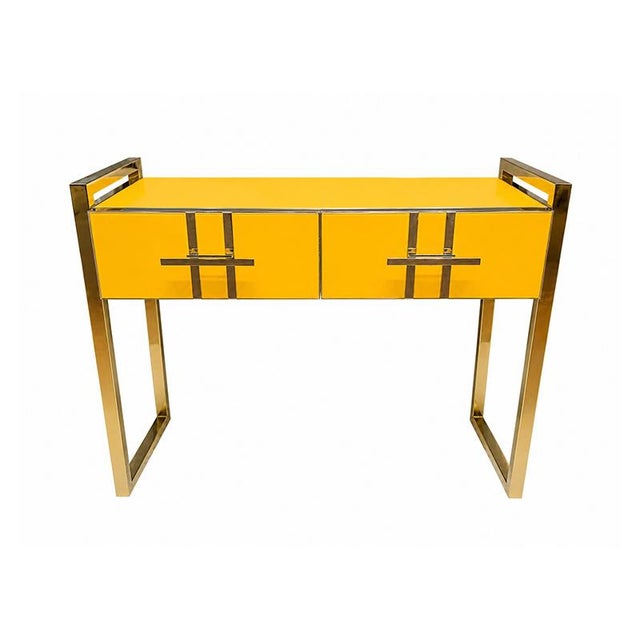 Console entirely handcrafted, with a wooden structure covered in yellow glass. Enriched with a tubular brass frame....