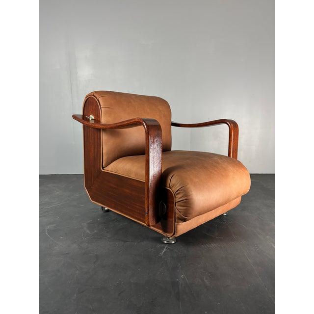 Lovely proportioned club or lounge chair in wood with reupholstered leather. According to the seller it originated form...